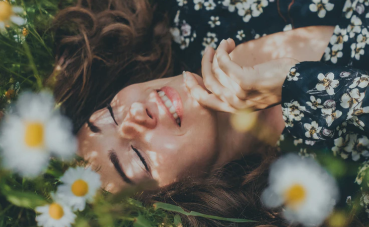 Woman laying in field of Flowers