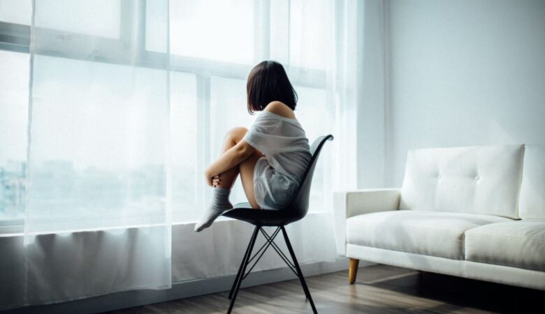 girl on chair feeling single and lonely