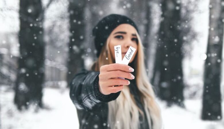 Woman in snow holding goodbye tags