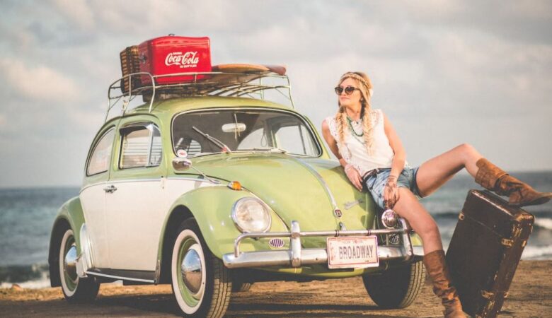 solo woman traveller confidently with suitcase in front of beetle car