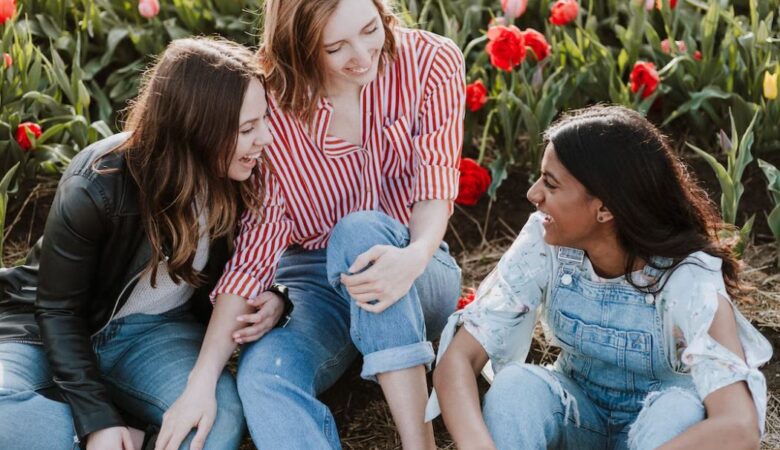 group of 20 year old friends laughing in poppy field