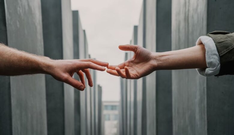 hands barely touching representing friendship drifting apart