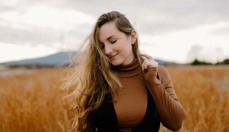 Happy confident woman in barley field