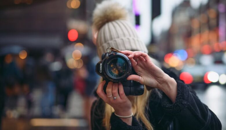 woman taking photo of camera with new york backdrop