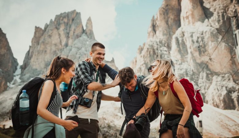 friends laughing together in front of mountain