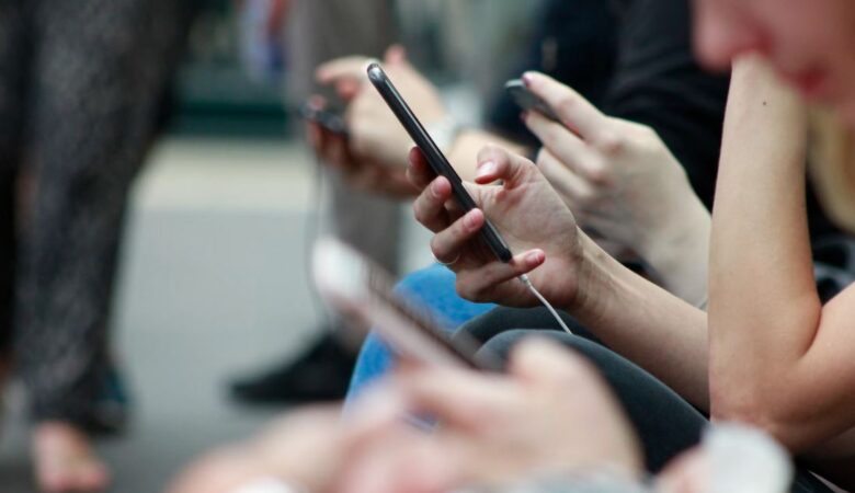 woman on phone in busy train carriage with everyone on their phones