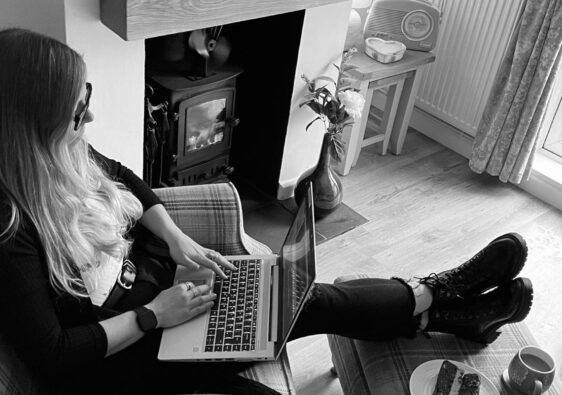 Amy Roullier writing in her living room